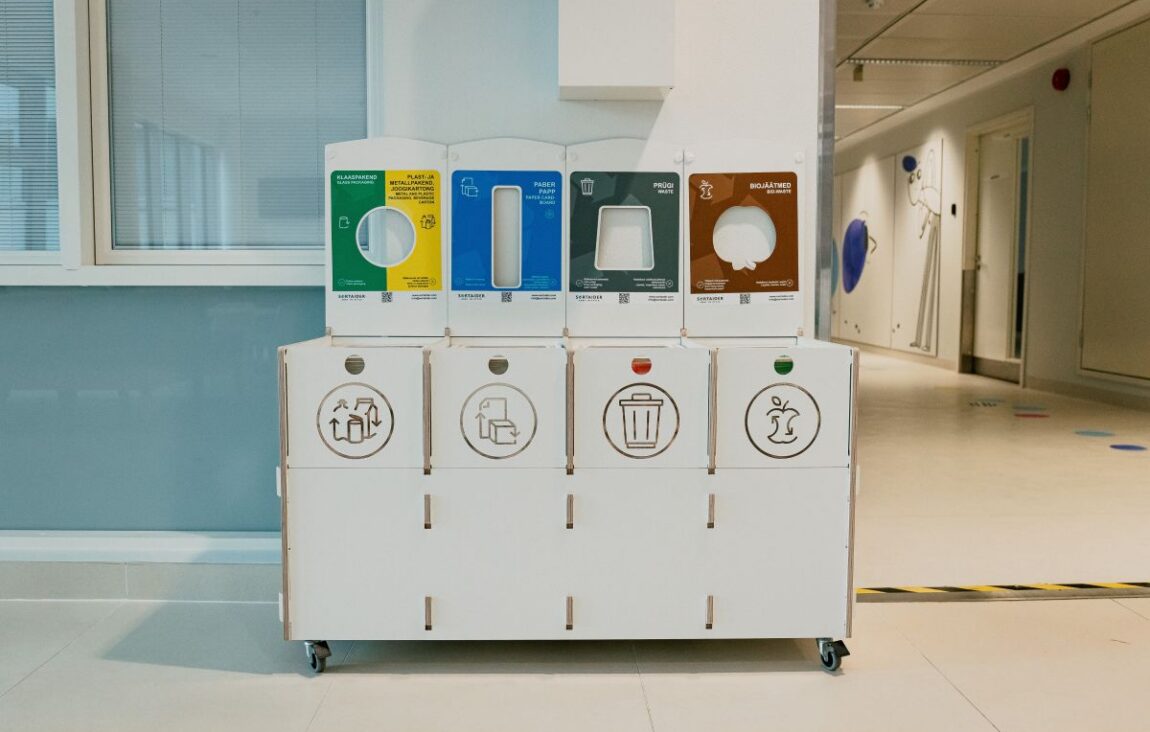 Recycling bins for hospitals with clear labels for glass, plastic, paper, waste, and bio waste.