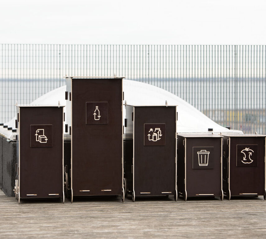 Modern wooden waste bins for home use with separate compartments for glass, packaging, mixed, and bio waste.