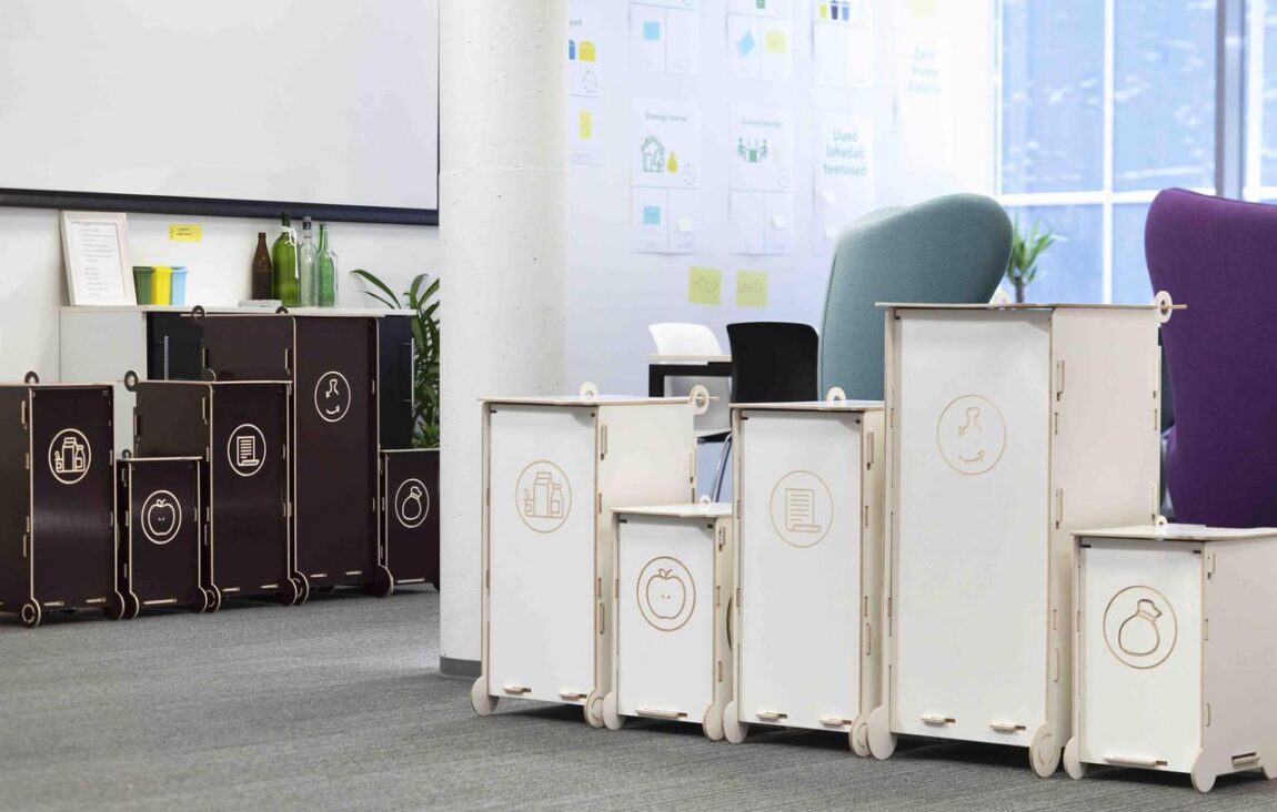 Modern modular waste bins for sorting, suitable for offices and educational environments, featuring clear symbols for different waste types.