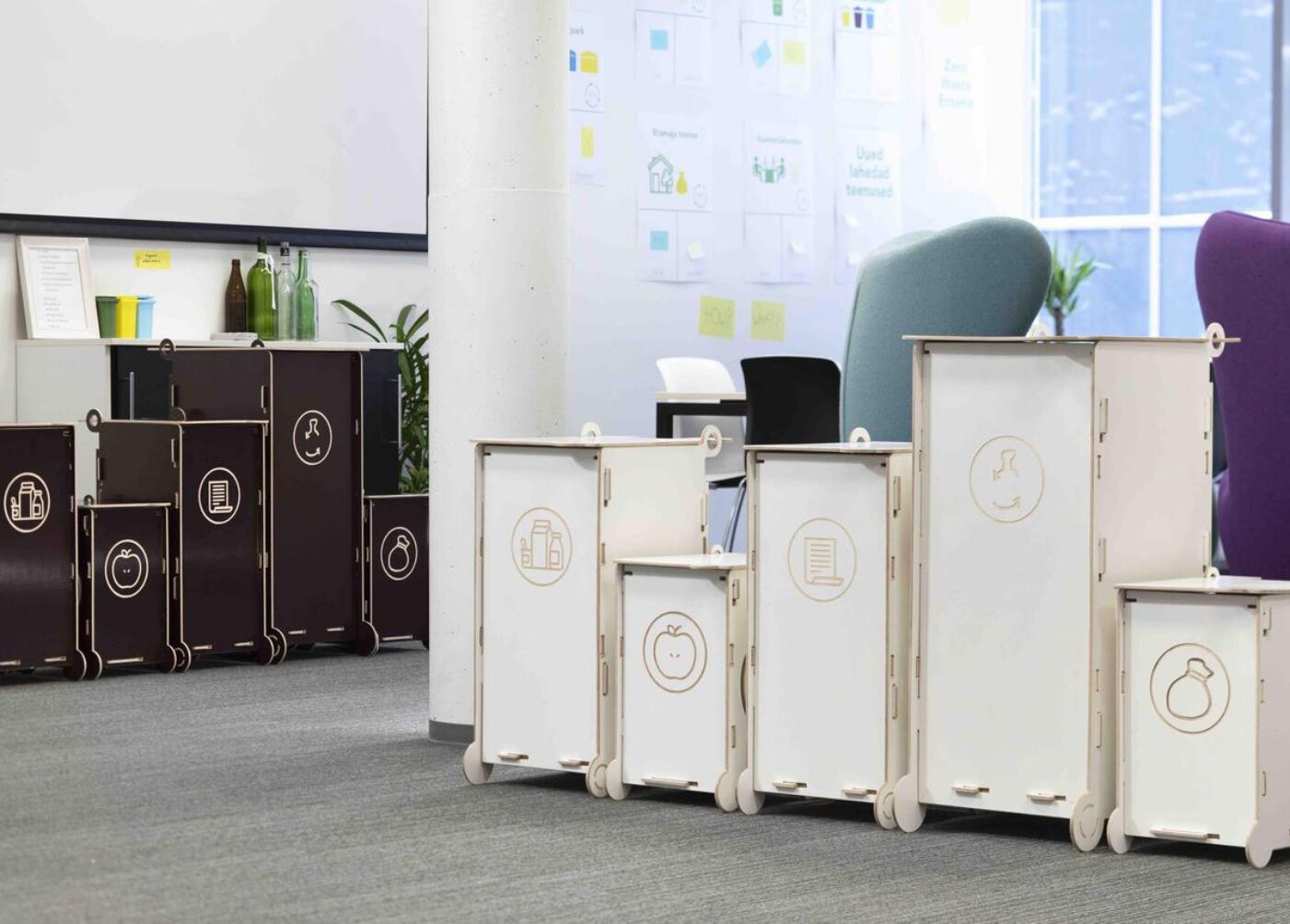 Modern modular waste bins for sorting, suitable for offices and educational environments, featuring clear symbols for different waste types.