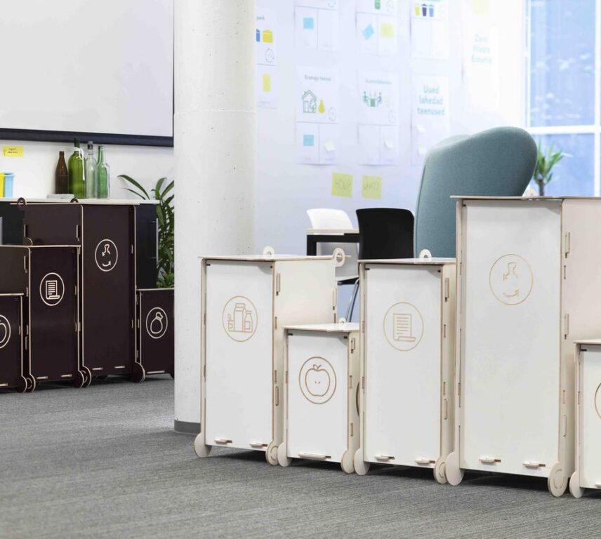 Modern modular waste bins for sorting, suitable for offices and educational environments, featuring clear symbols for different waste types.