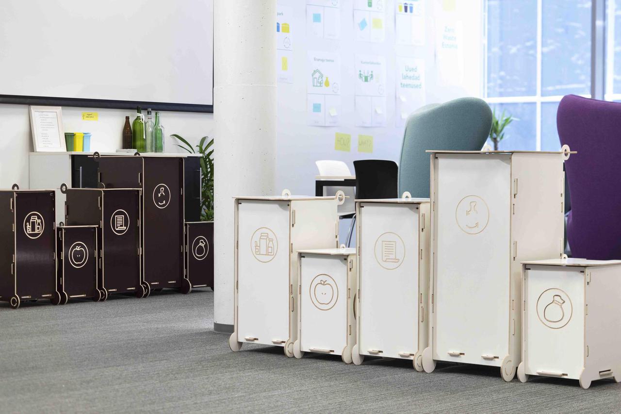 Modern modular waste bins for sorting, suitable for offices and educational environments, featuring clear symbols for different waste types.