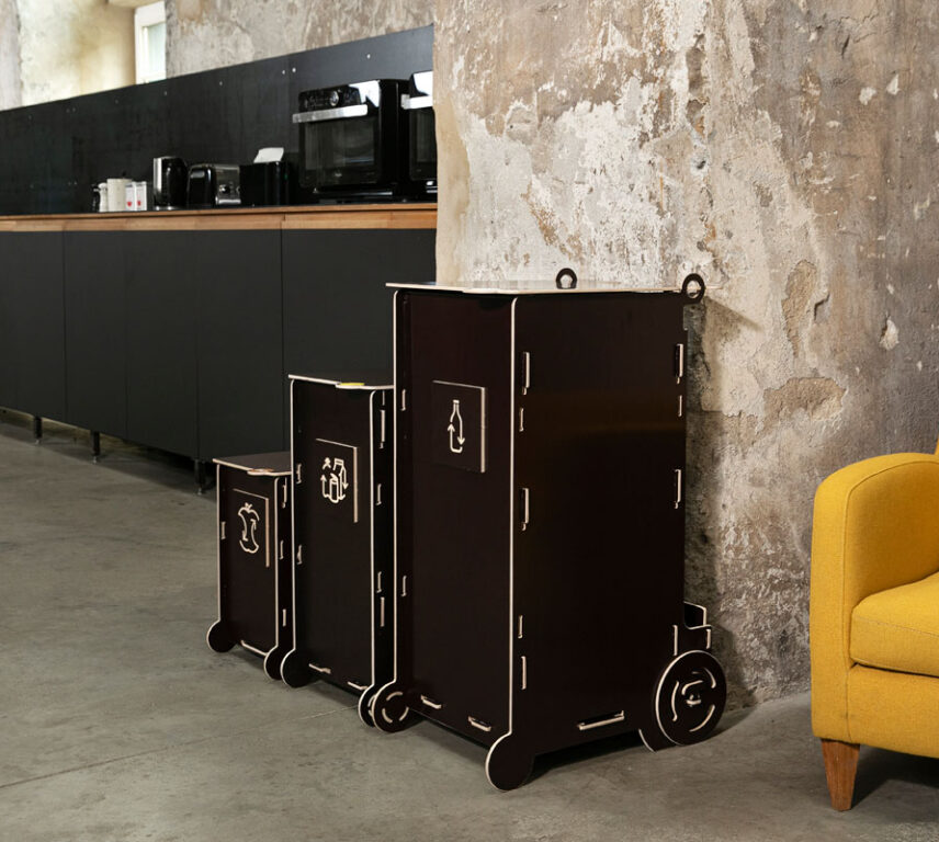 Modern dark-toned waste bins for sustainable living, featuring separate sections for glass, paper, packaging, and bio waste in a stylish interior.