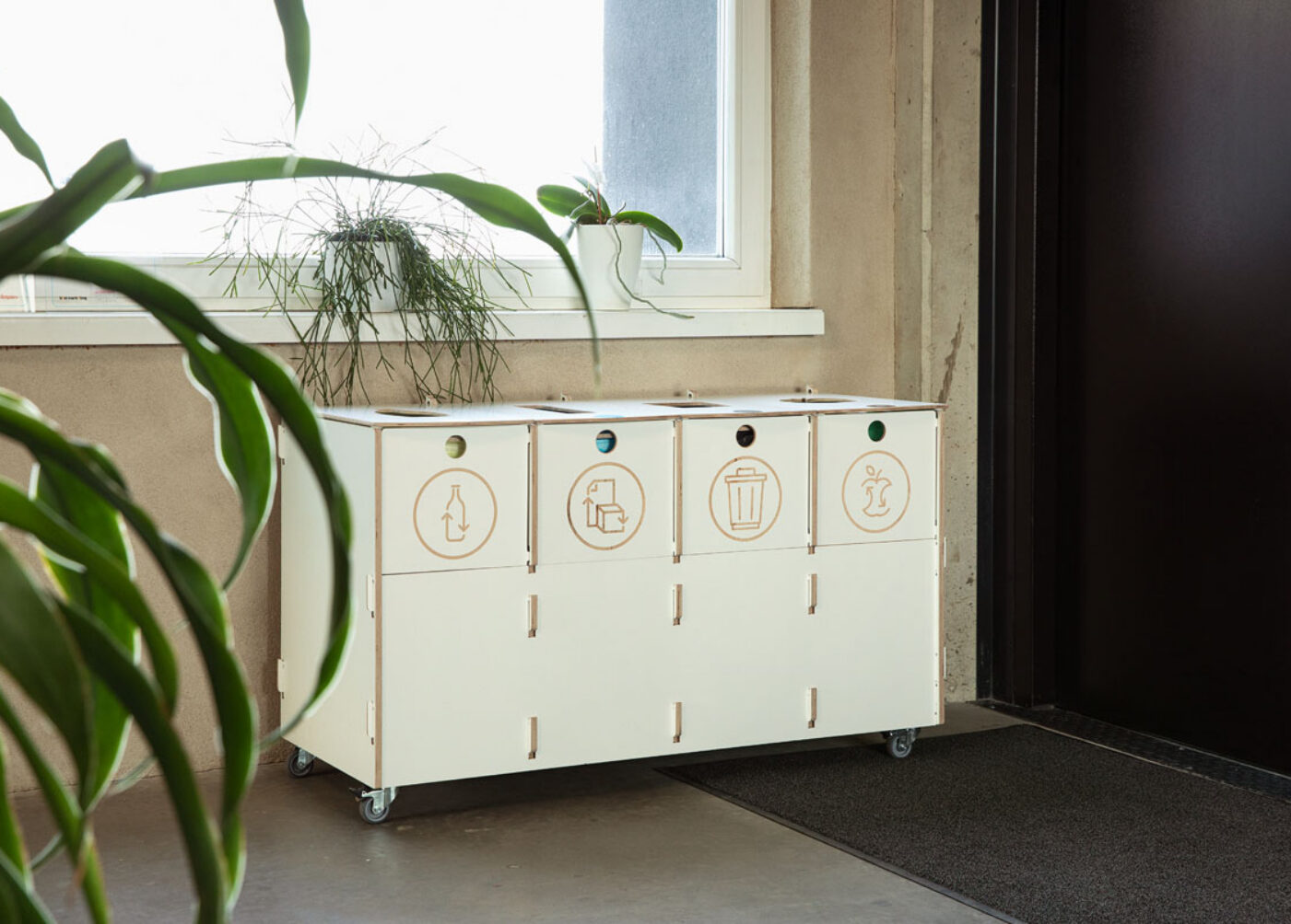 Modern office interior featuring recycling bins for paper, plastic, mixed waste, and biowaste, installed at Estonian Traffic Insurance Fund – Sortaider.