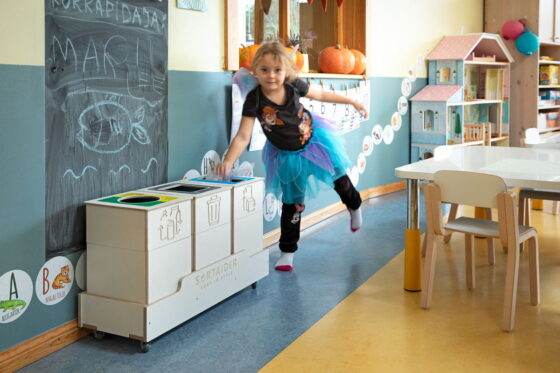 Child using Sortaider waste sorting bins in a classroom – promoting eco-friendly habits