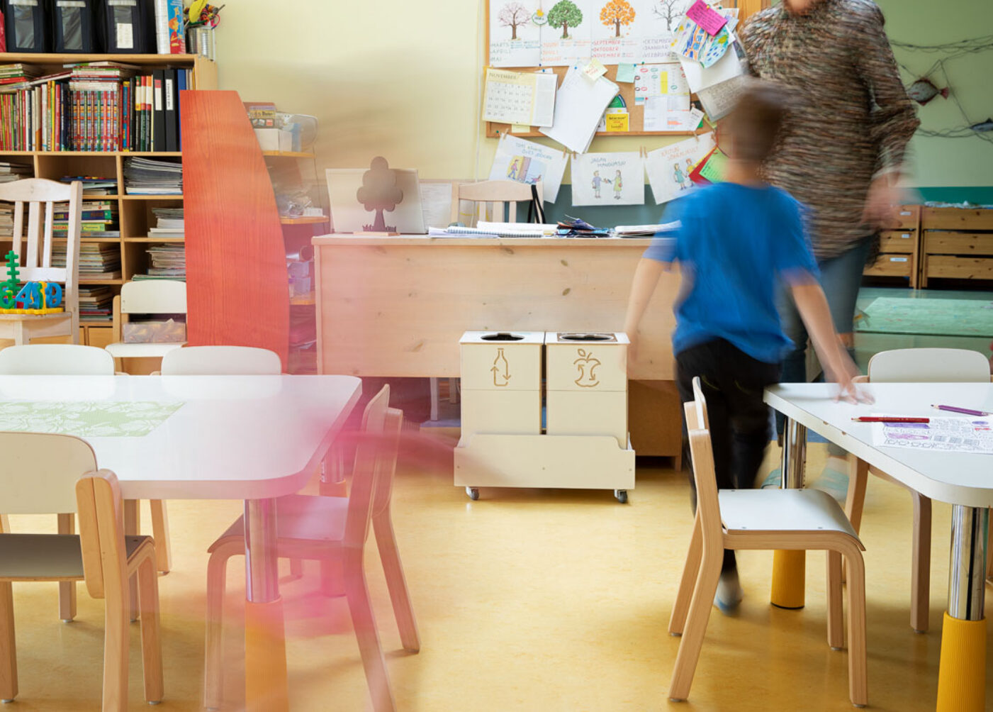 Recycling bins for indoor activity areas placed near exits to support discreet waste sorting.