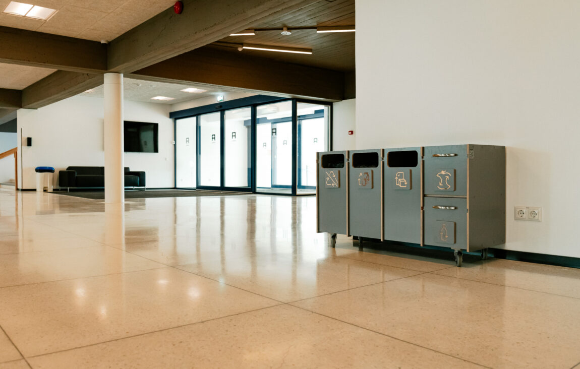 Recycling bins used for educational purposes to explain waste sorting.