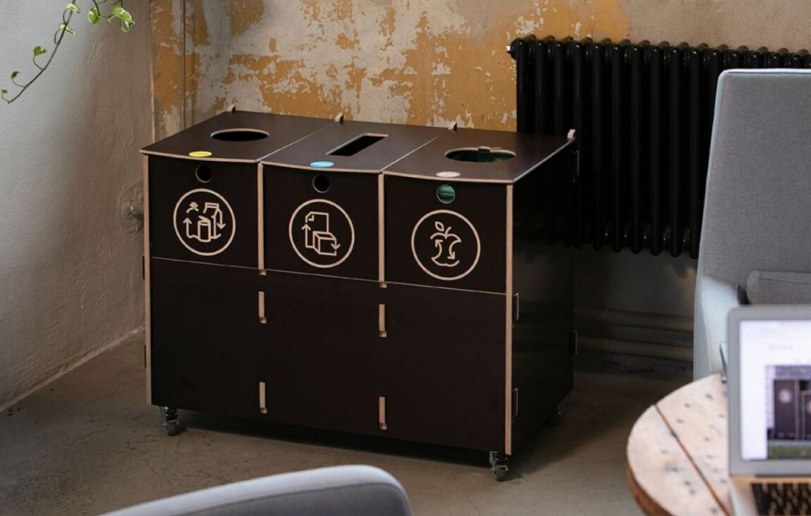 Recycling bins with lids in use, showing a clean and contained waste sorting setup.
