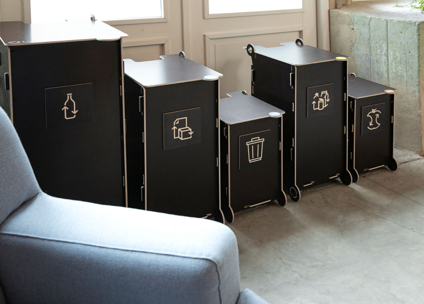 Waste bins for co-working spaces placed in a shared area to support easy waste sorting for rotating users.