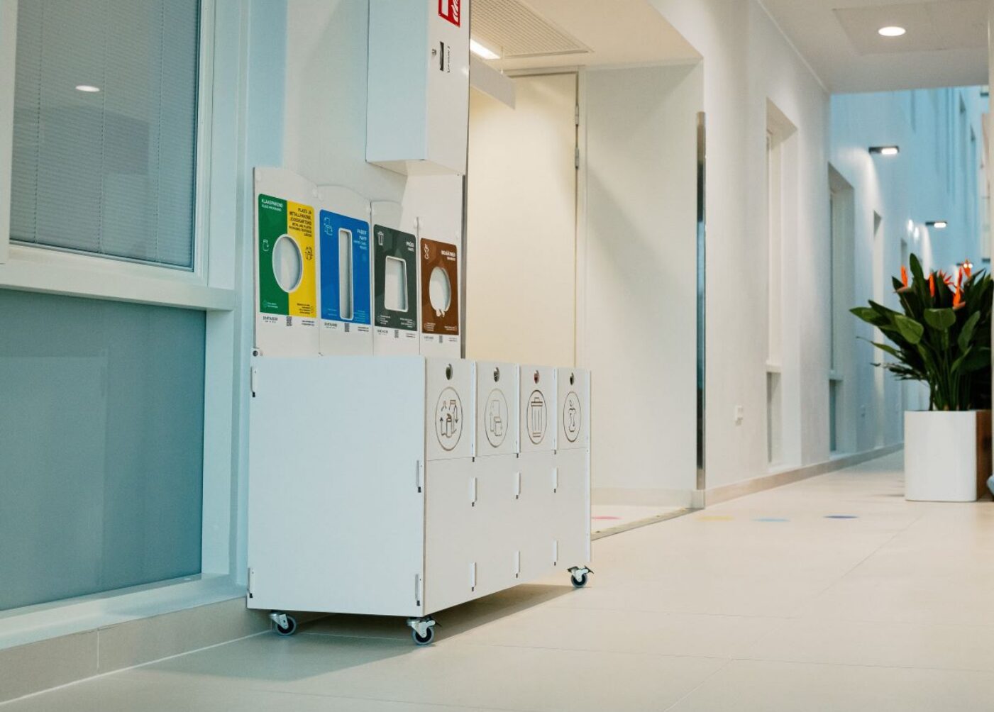 Waste bins for office corridor placed at corridor ends to support disposal.