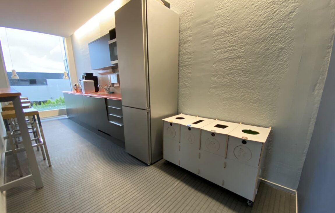 Waste bins for office transition spaces placed along walkways to support intuitive waste sorting.