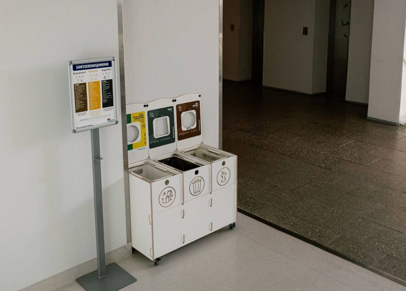 Labeled recycling bins in a school promoting easy trash removal and proper waste sorting for students.