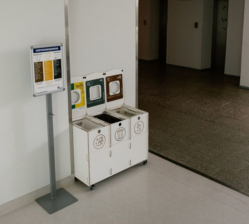 Labeled recycling bins in a school promoting easy trash removal and proper waste sorting for students.