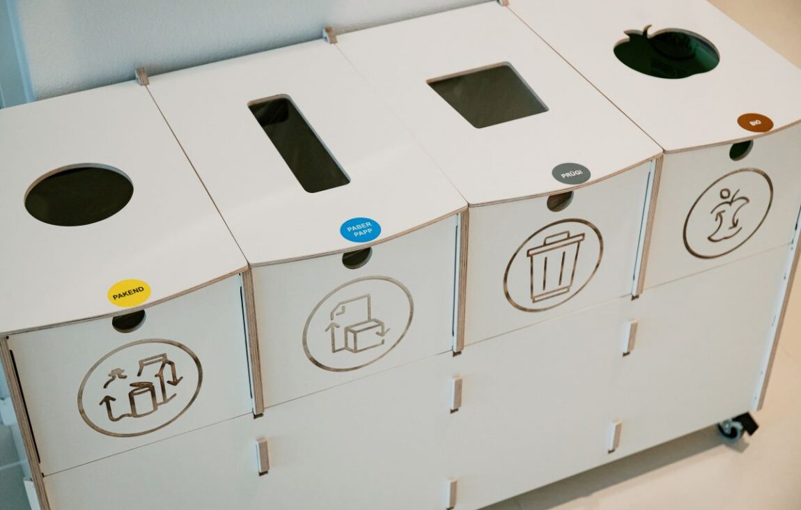 Recycling bins for sustainable waste sorting in kindergarten are used by children to sort paper and cardboard promoting sustainable recycling and effective waste management