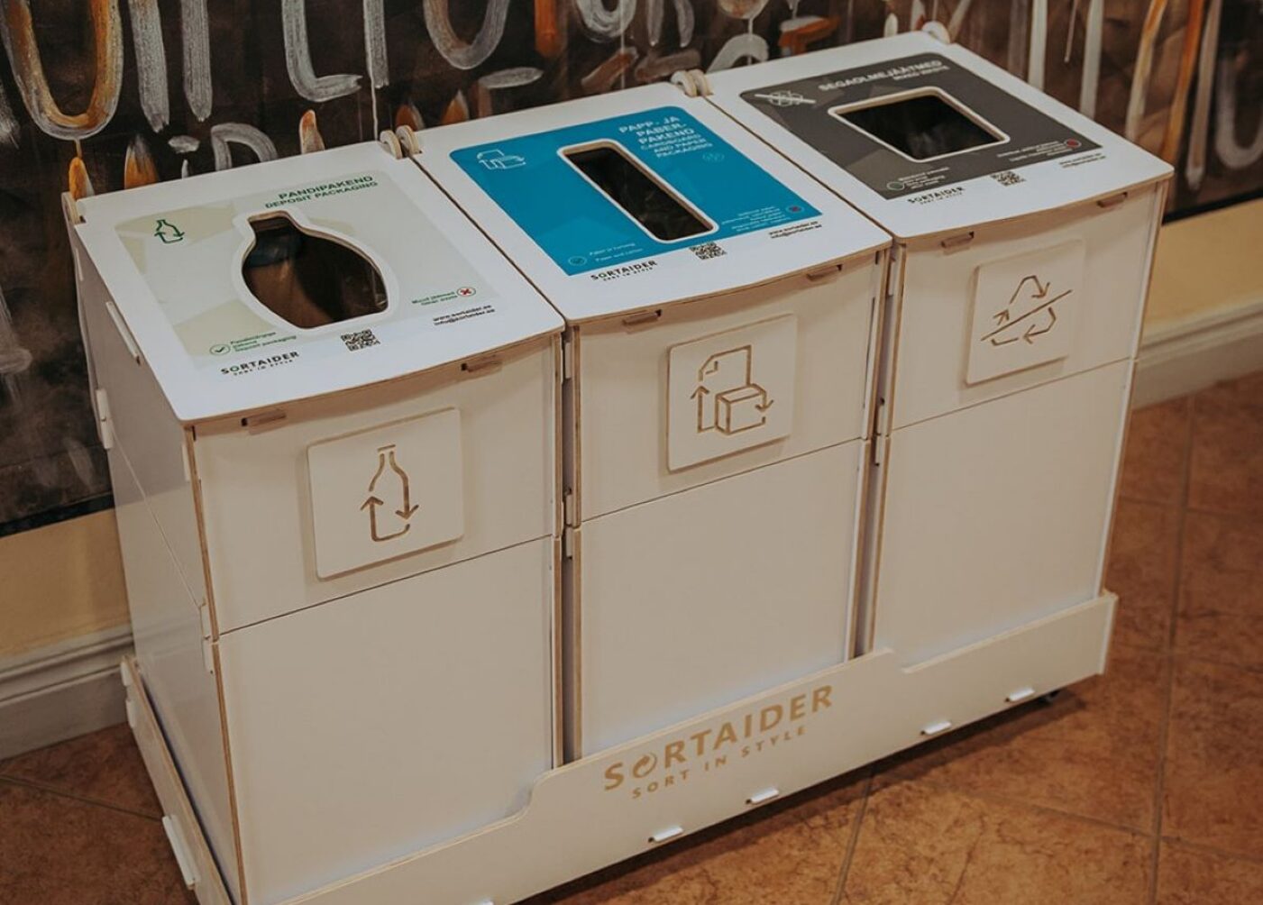 Waste sorting cans in the library are used by visitors to sort paper, cardboard, and general trash, demonstrating easy recycling and supporting efficient waste management.